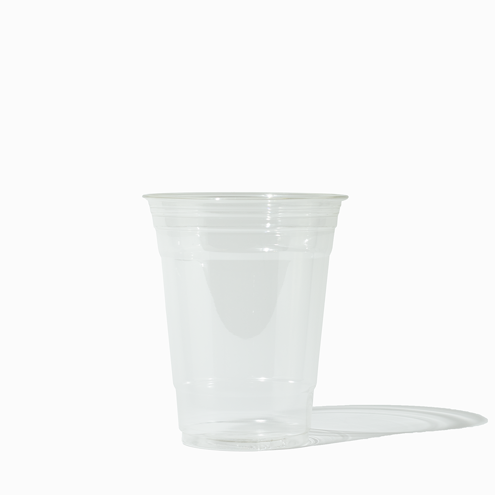 A crystal-clear UNIQ 16 oz shatter-proof PET cold cup from a 1000-count bulk case, featuring a universal 98mm rim for standard wholesale beverage supplies.