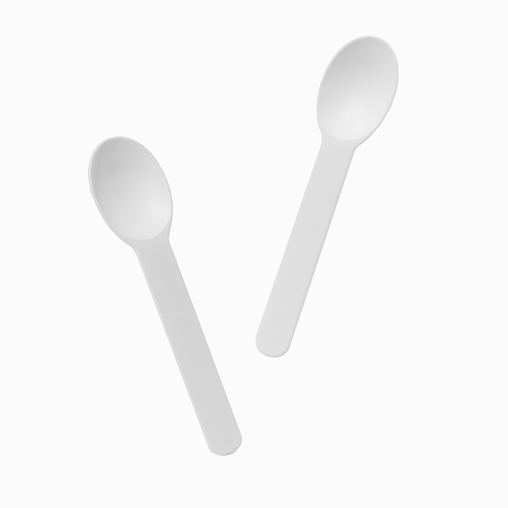 White rigid plastic spoons arranged for professional catering and heavy dessert service.