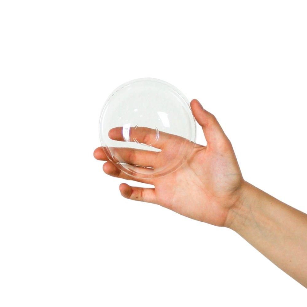 12 oz clear dome lid held in hand for scale