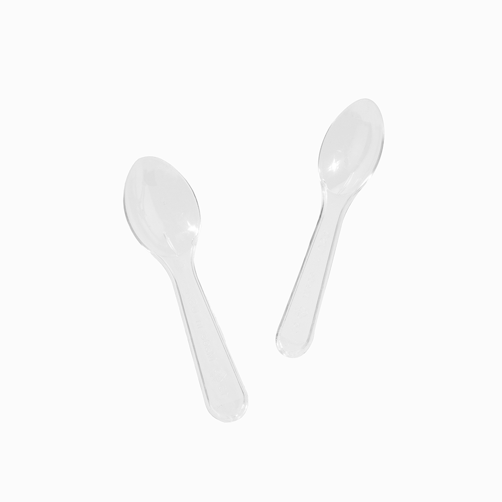 Clear mini plastic tasting spoons arranged for premium dessert and cosmetic sampling.