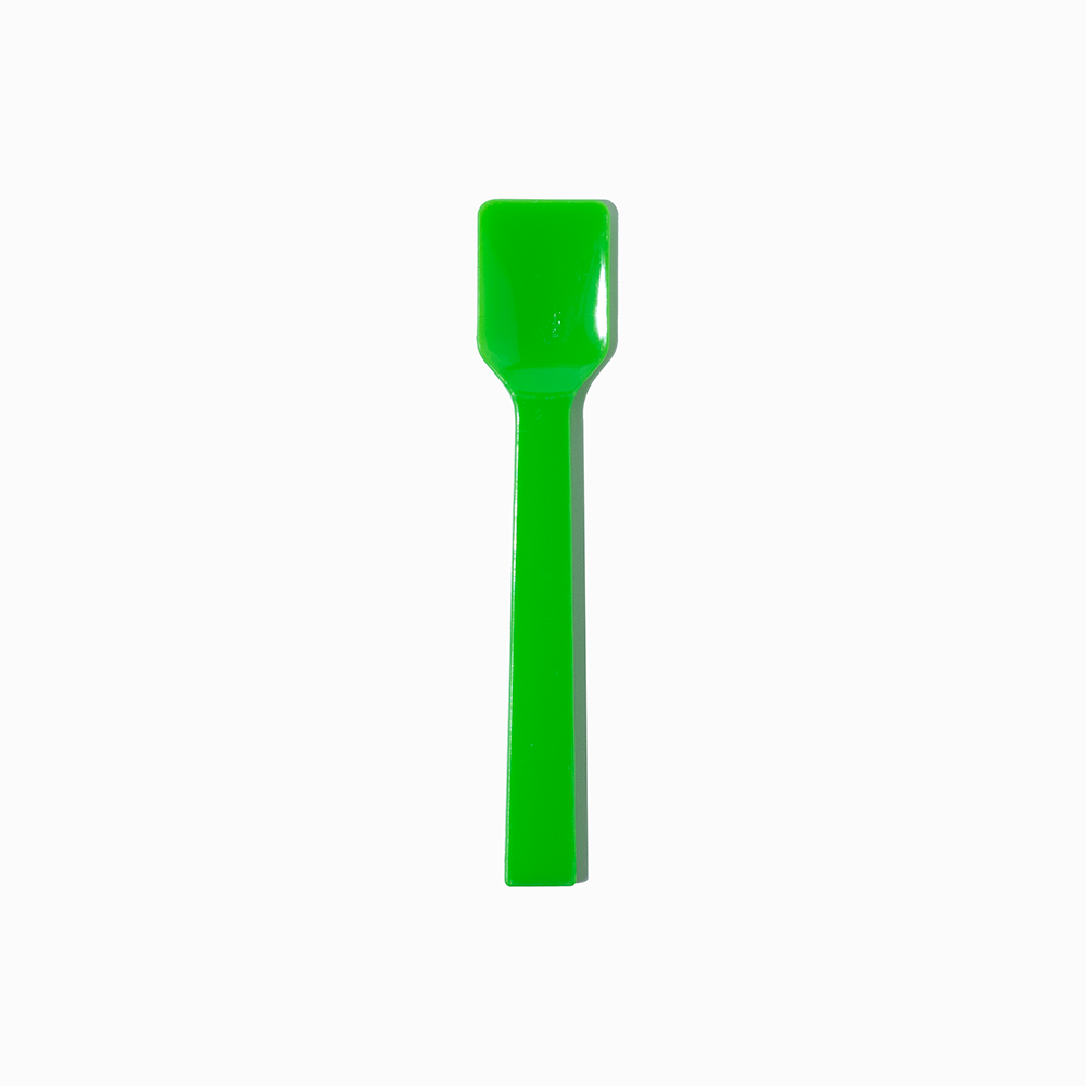 Green flat-edge plastic gelato spoon - Single close-up for authentic gelato shops.