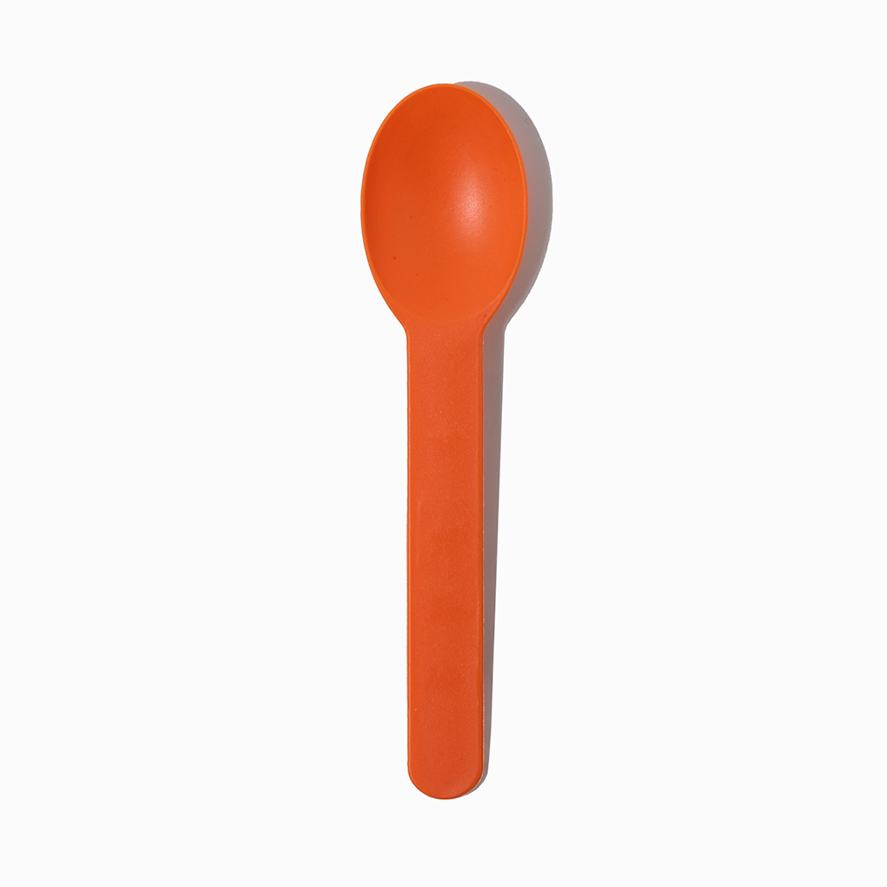Orange heavy-duty plastic ice cream spoon - Single close-up for premium frozen treats.