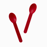 Red commercial-grade plastic spoons in action for heavy food service and catering.
