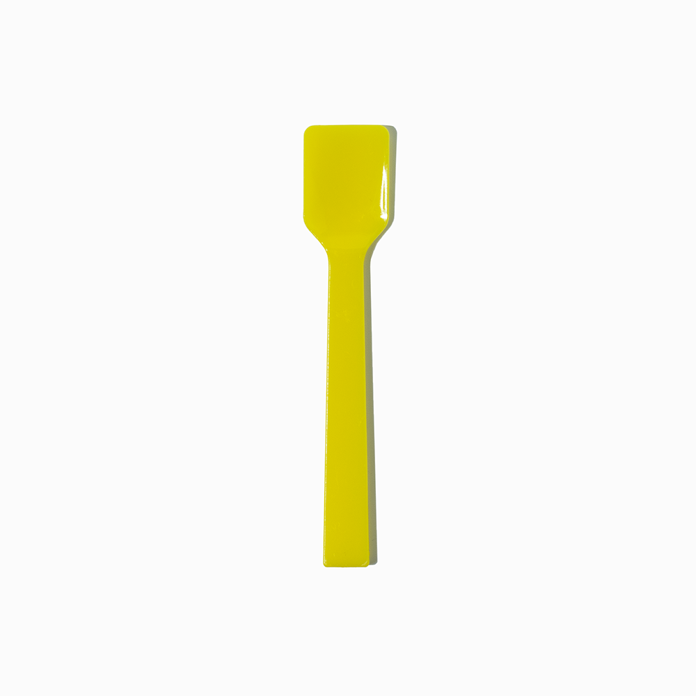 Yellow flat-edge plastic gelato spoon - Single close-up for commercial parlors.