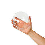 16 oz clear dome lid held in hand for scale